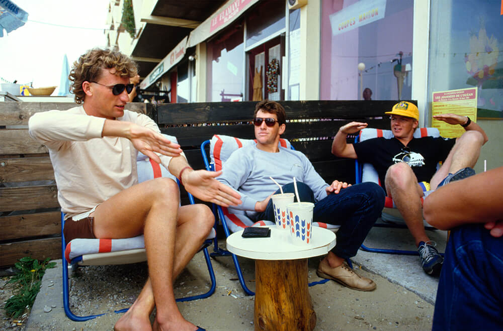 Image of men around table taken by Tom Carroll